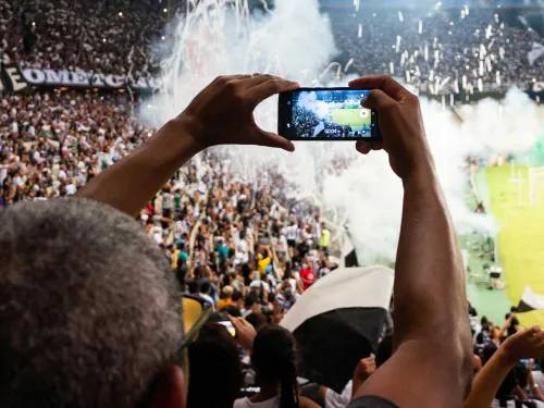 Person Taking Photo of Stage Stadium Presentation.